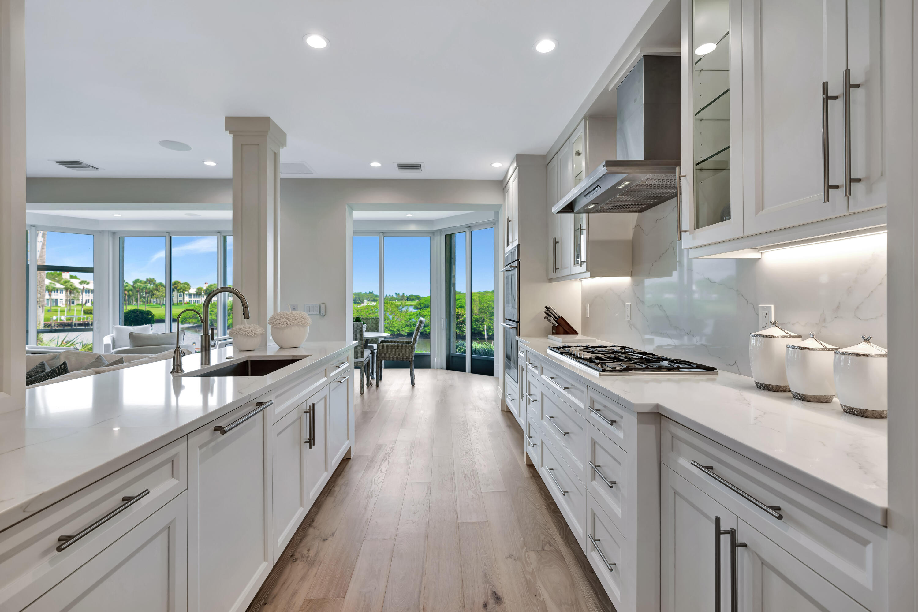 260 Eagle Drive Jupiter, FL 33477 - Photo 17 of 41 a large kitchen with stainless steel appliances granite countertop a lot of counter space and wooden floors