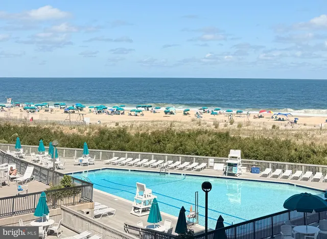 a view of swimming pool with outdoor seating
