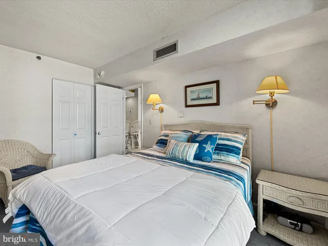 a bedroom with a bed and painting on the wall