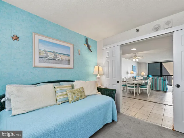 a living room with furniture and a dining table with wooden floor