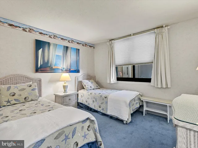 a bedroom with two beds and a window