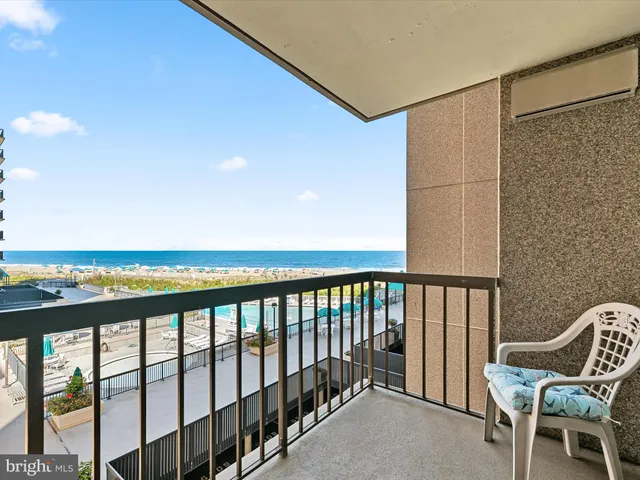a balcony with chairs and city view