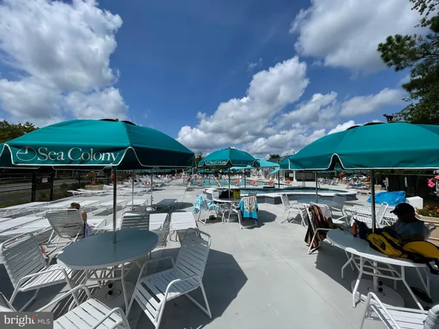 a view of a swimming pool with chairs in patio