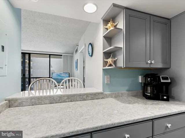 a kitchen with a refrigerator and cabinets