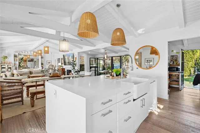 a living room with furniture fireplace and large windows