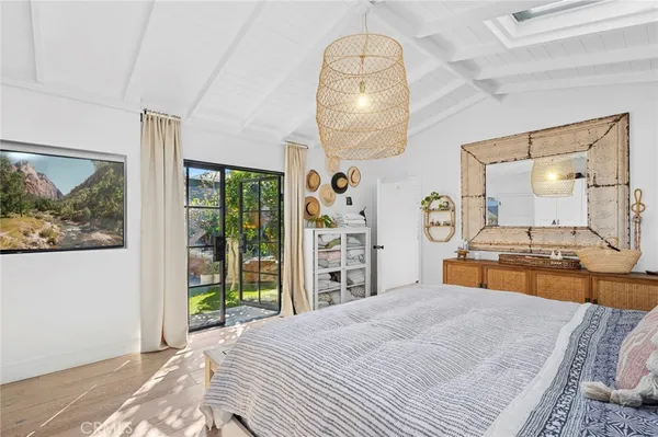 a view of a swimming pool with lawn chairs under an umbrella