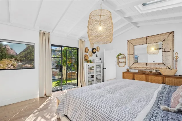 a view of a swimming pool with lawn chairs under an umbrella