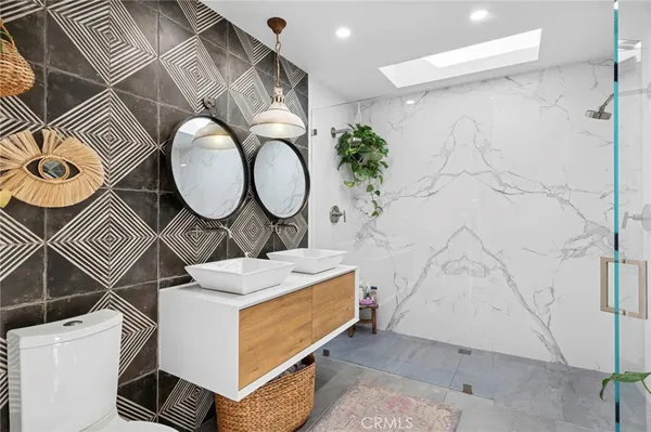 a bedroom with a bed a mirror and a window