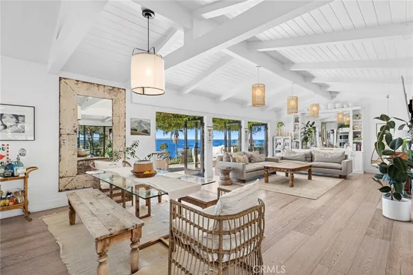 a living room with fireplace furniture and a chandelier