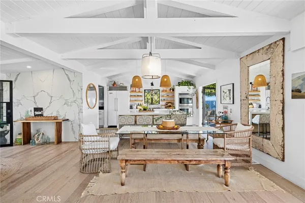 a living room with fireplace furniture and a large window