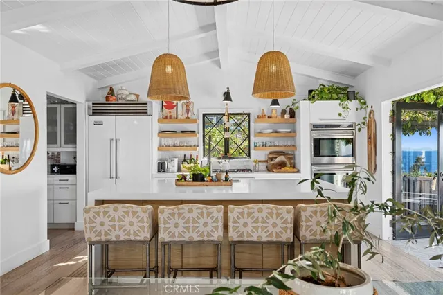 a bathroom with a sink a mirror and next to a window