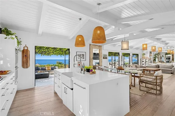 a view of a kitchen with furniture and wooden floor