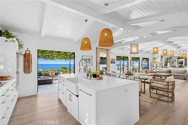 a view of a kitchen with furniture and wooden floor