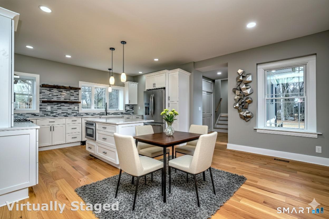 a kitchen with kitchen island granite countertop wooden floors and white cabinets