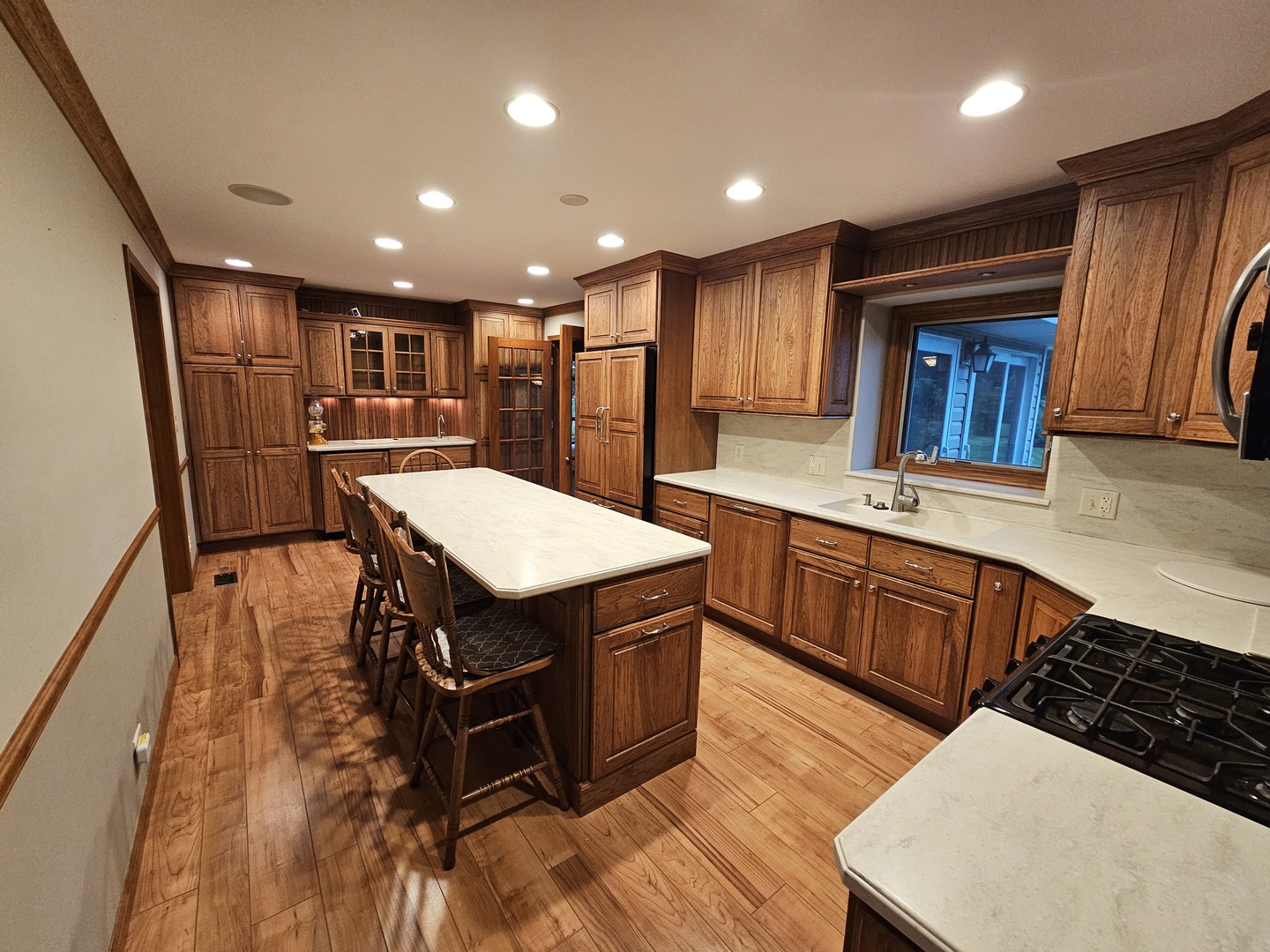 7N715 Sycamore Road St. Charles, IL 60175 - Photo 9 of 20 a kitchen with stainless steel appliances granite countertop a table chairs sink and wooden floor