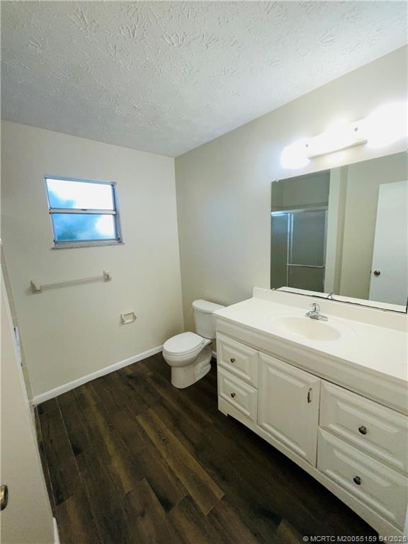 941 Southwest Fenway Road Port St. Lucie, FL 34953 - Photo 11 of 15 a bathroom with a toilet sink and mirror