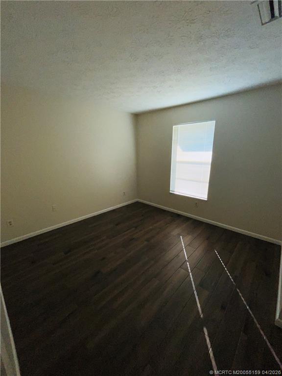 941 Southwest Fenway Road Port St. Lucie, FL 34953 - Photo 12 of 15 a view of an empty room with wooden floor and a window