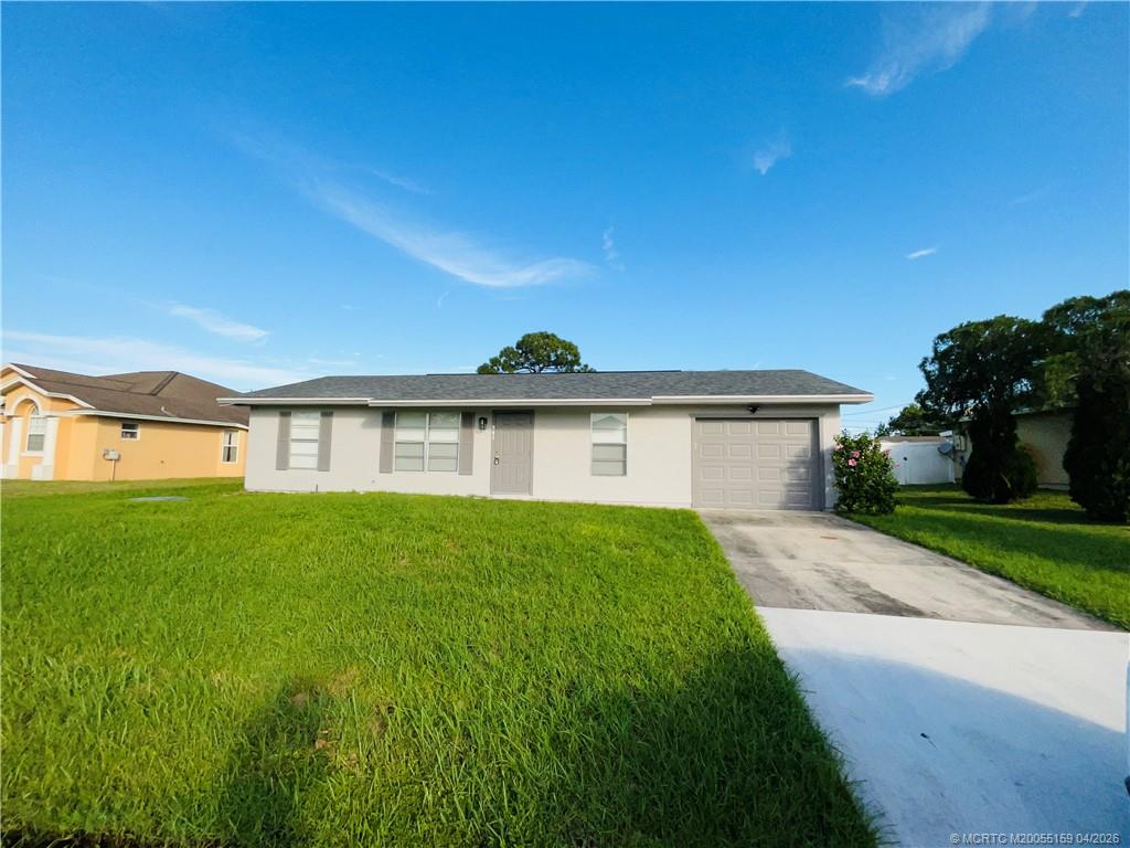 941 Southwest Fenway Road Port St. Lucie, FL 34953 - Photo 15 of 15 a view of a house with a yard