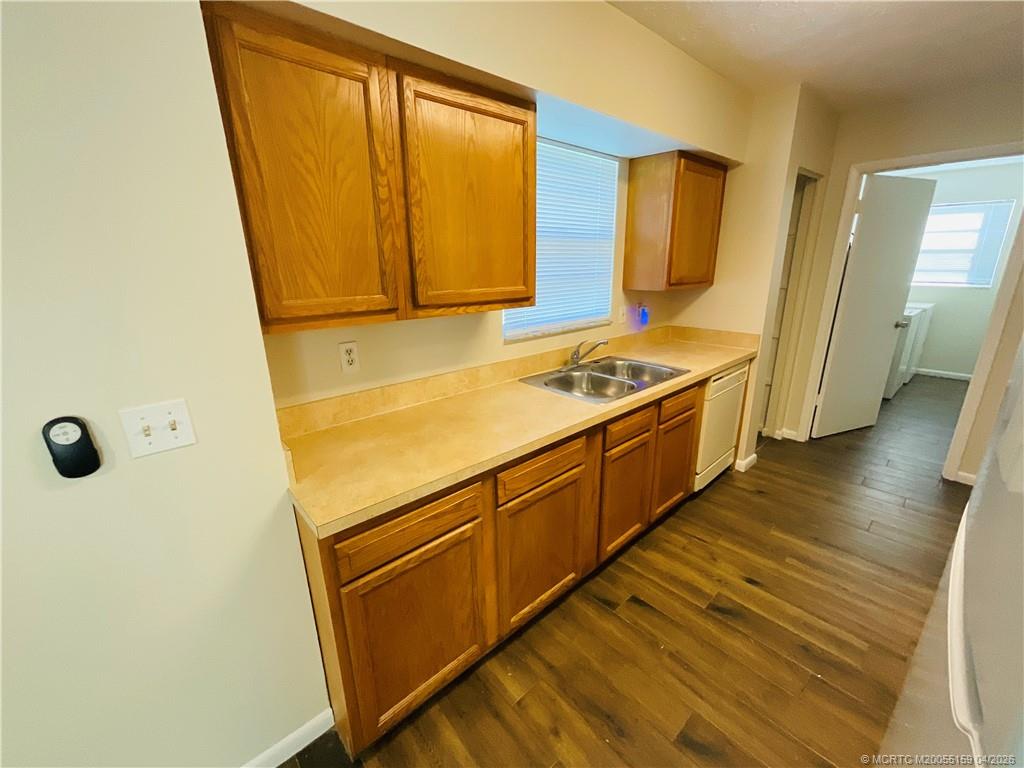 941 Southwest Fenway Road Port St. Lucie, FL 34953 - Photo 6 of 15 a kitchen with a sink a refrigerator and a stove