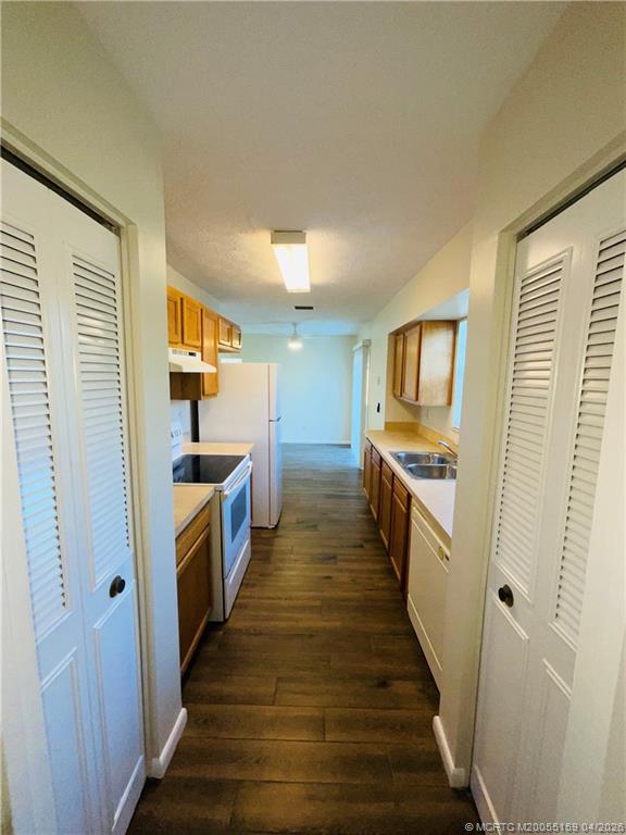 941 Southwest Fenway Road Port St. Lucie, FL 34953 - Photo 9 of 15 a kitchen with sink a counter top space and cabinets