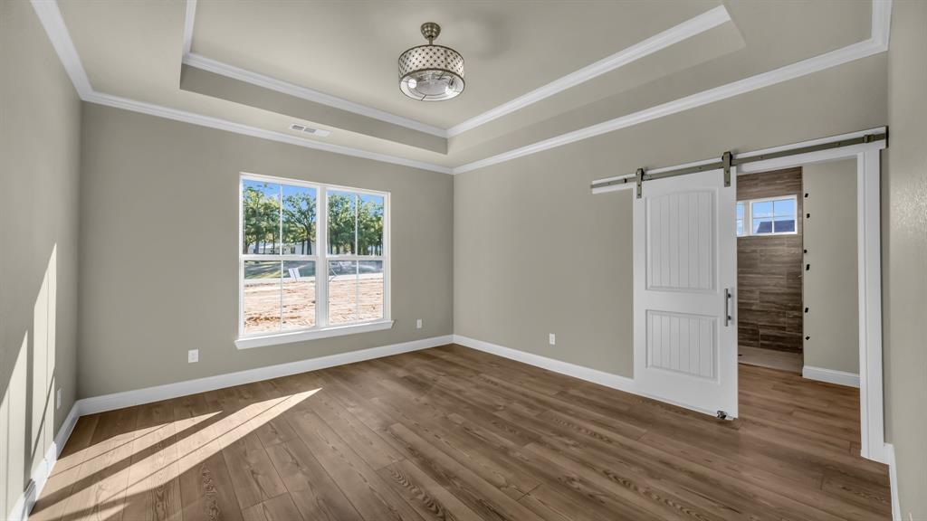 3451 Eleanor Tbd County Road Paradise, TX 76073 - Photo 14 of 25 a view of an empty room with wooden floor and a window