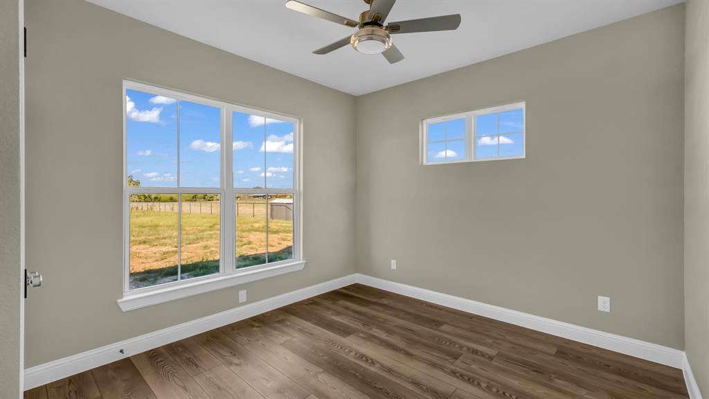 3451 Eleanor Tbd County Road Paradise, TX 76073 - Photo 19 of 25 a view of an empty room with wooden floor and windows
