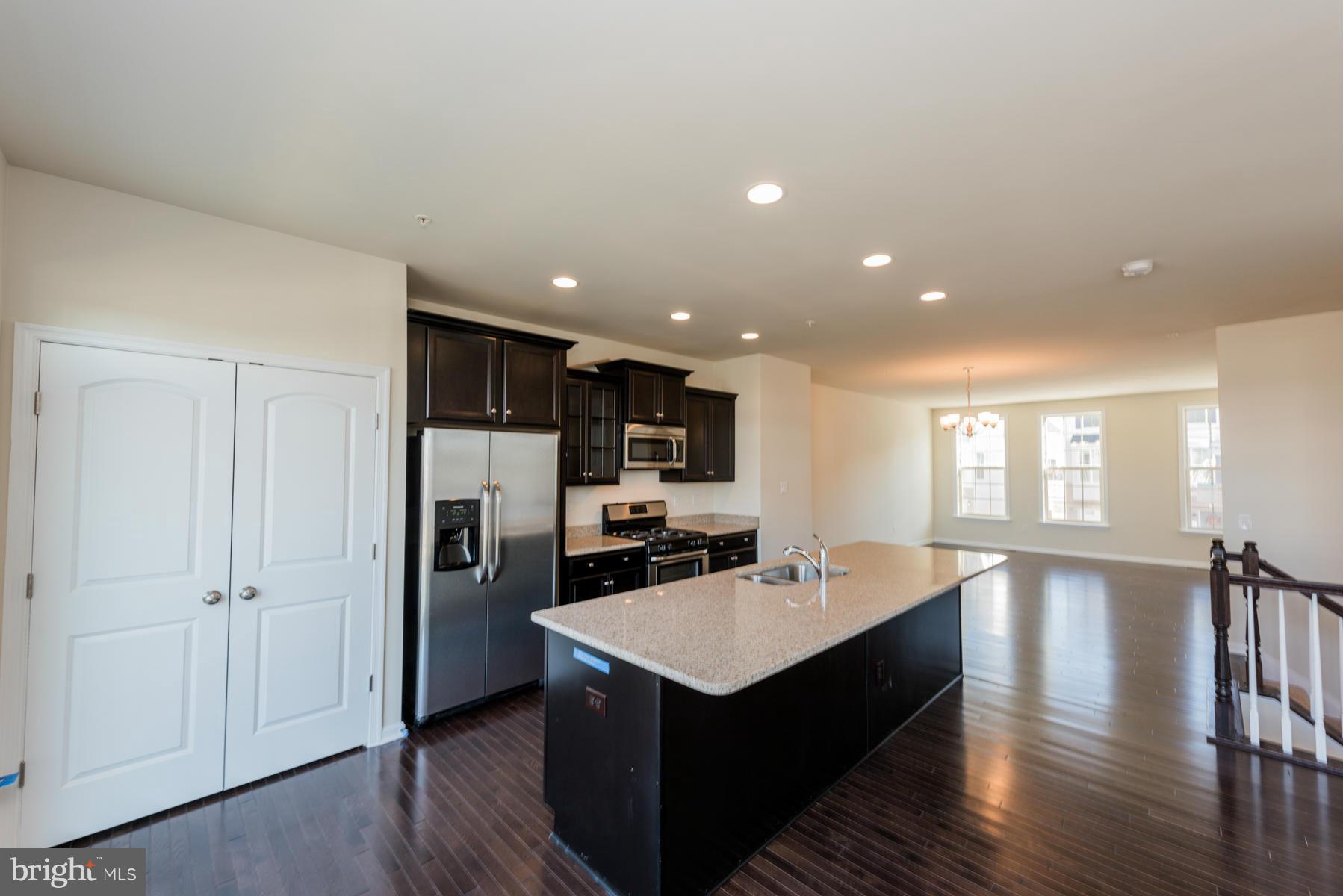 4716 Cambria Road Frederick, MD 21703 - Photo 11 of 27 a kitchen with a refrigerator a sink dishwasher and a refrigerator with wooden floor