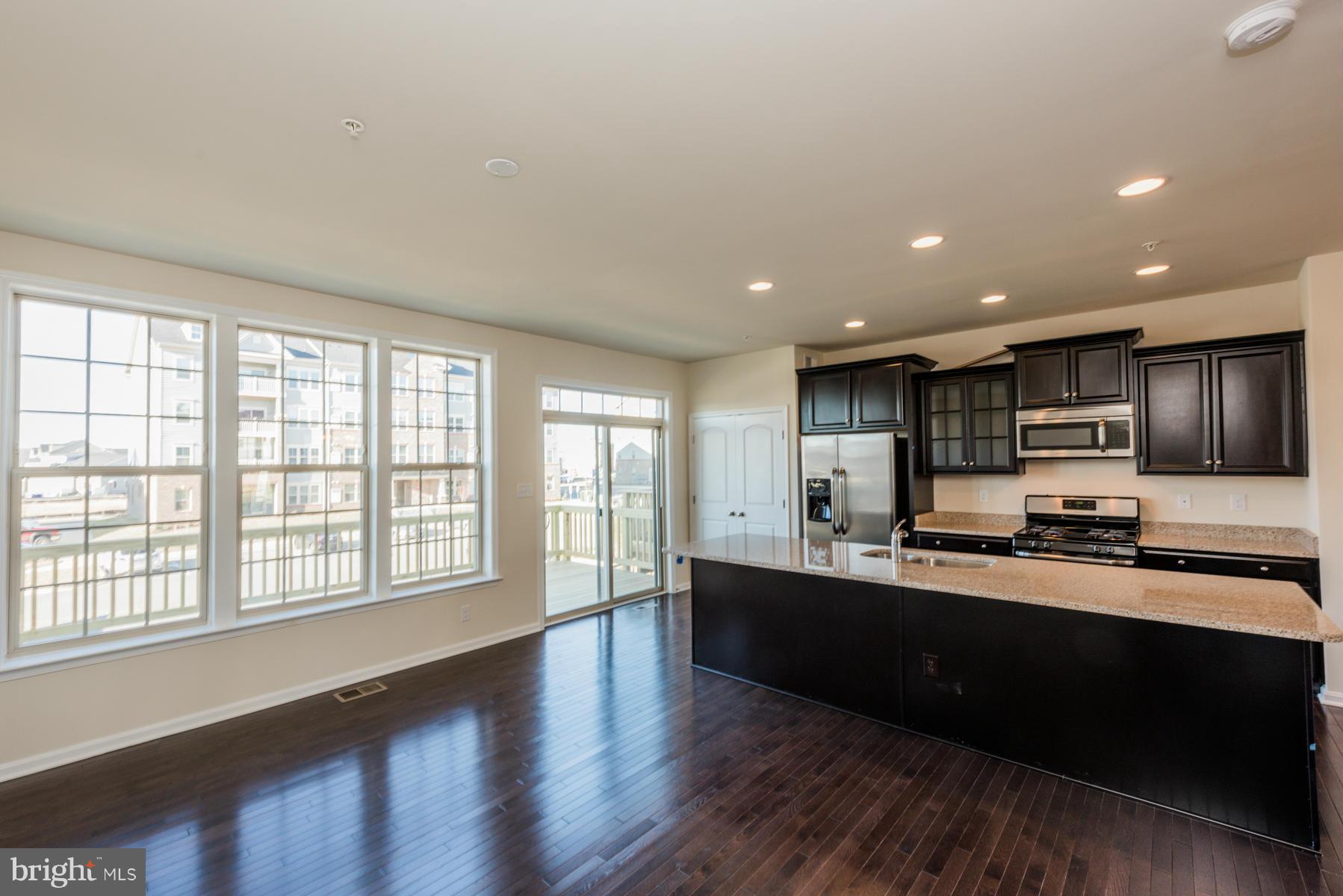 4716 Cambria Road Frederick, MD 21703 - Photo 12 of 27 a kitchen with stainless steel appliances sink a microwave and cabinets