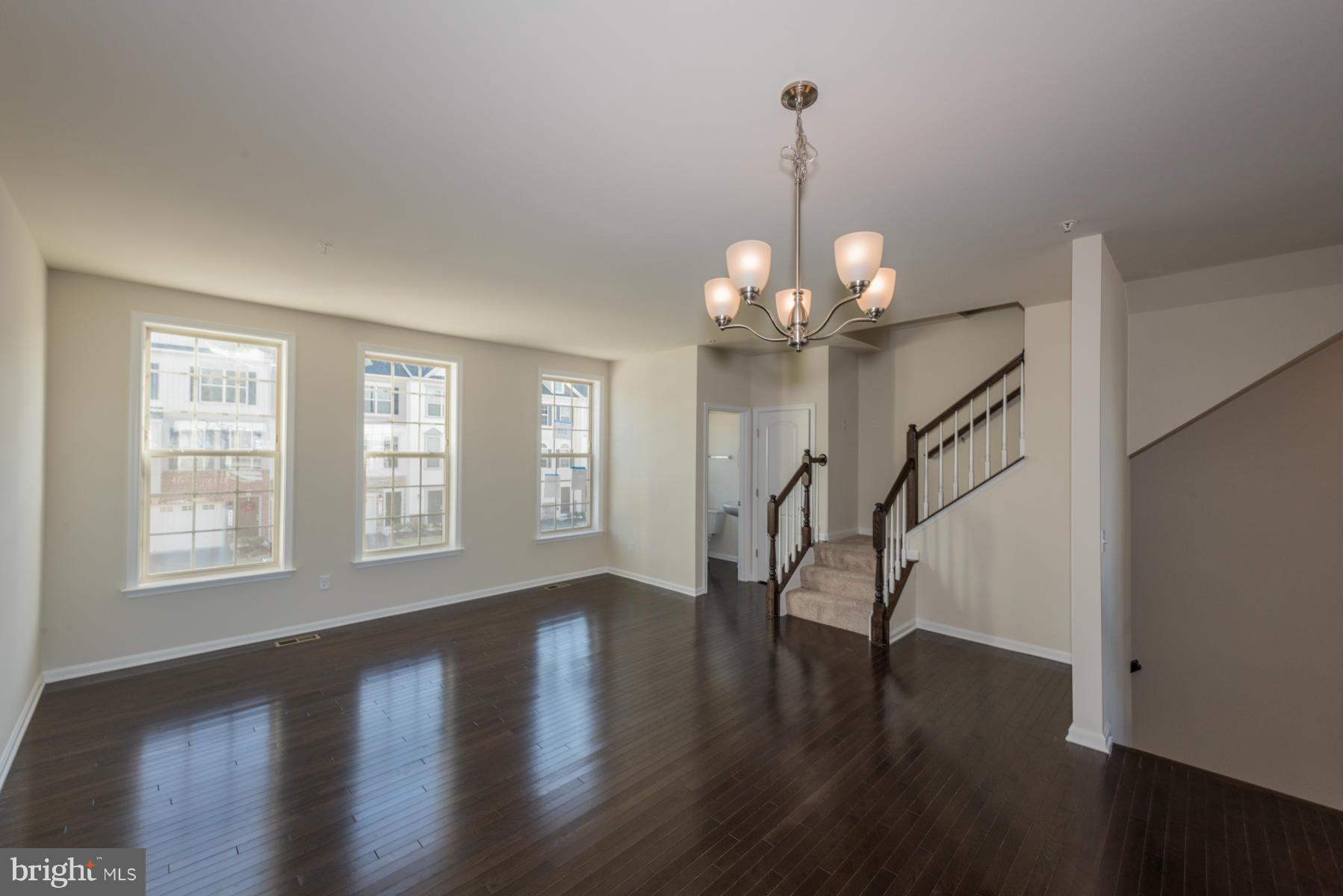 4716 Cambria Road Frederick, MD 21703 - Photo 3 of 27 a view of a room with wooden floor chandelier and windows