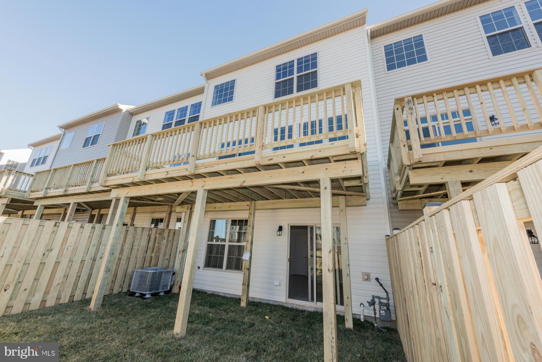 4716 Cambria Road Frederick, MD 21703 - Photo 27 of 27 a view of a house with wooden deck and furniture