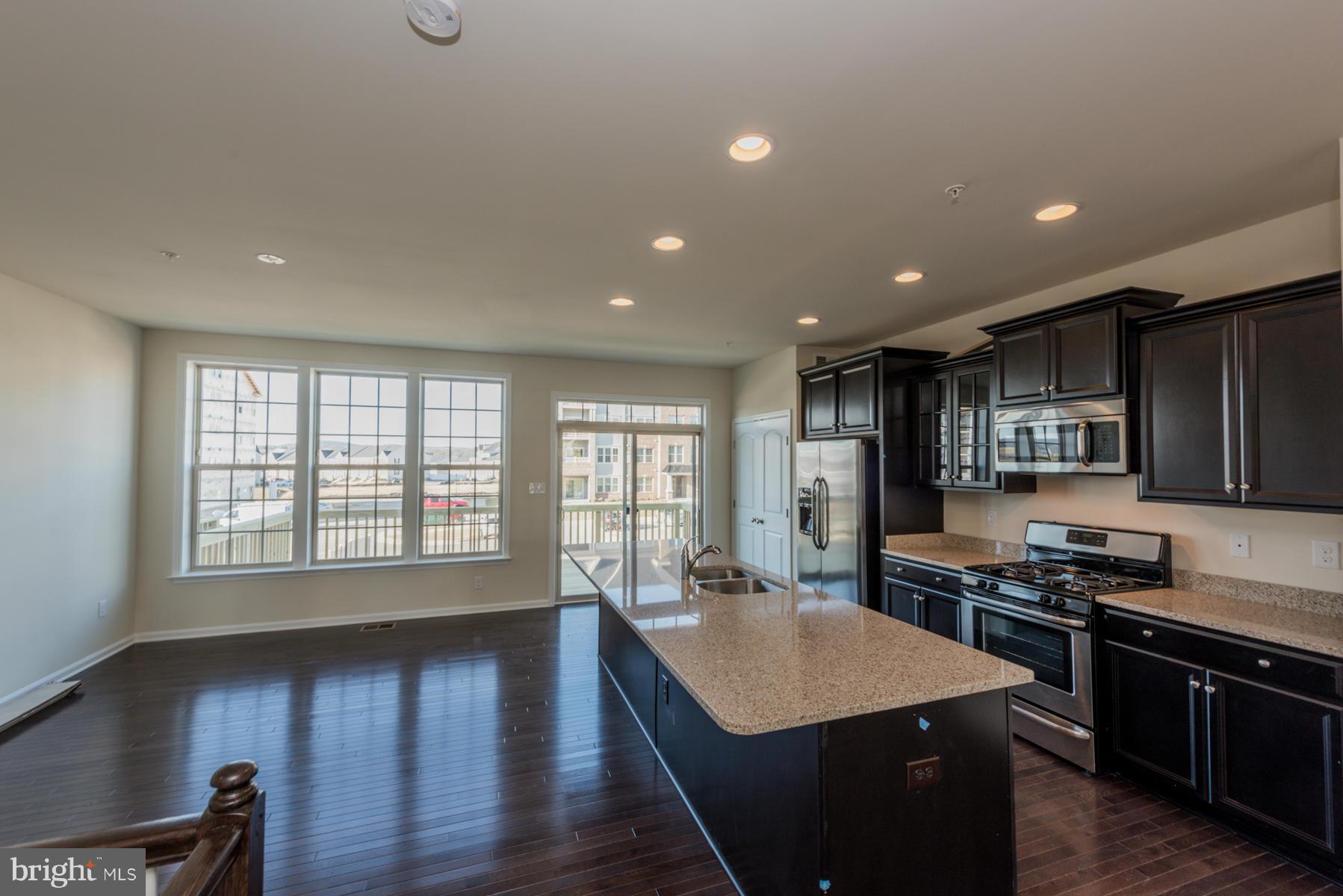 4716 Cambria Road Frederick, MD 21703 - Photo 7 of 27 a kitchen with stainless steel appliances granite countertop a sink stove and refrigerator