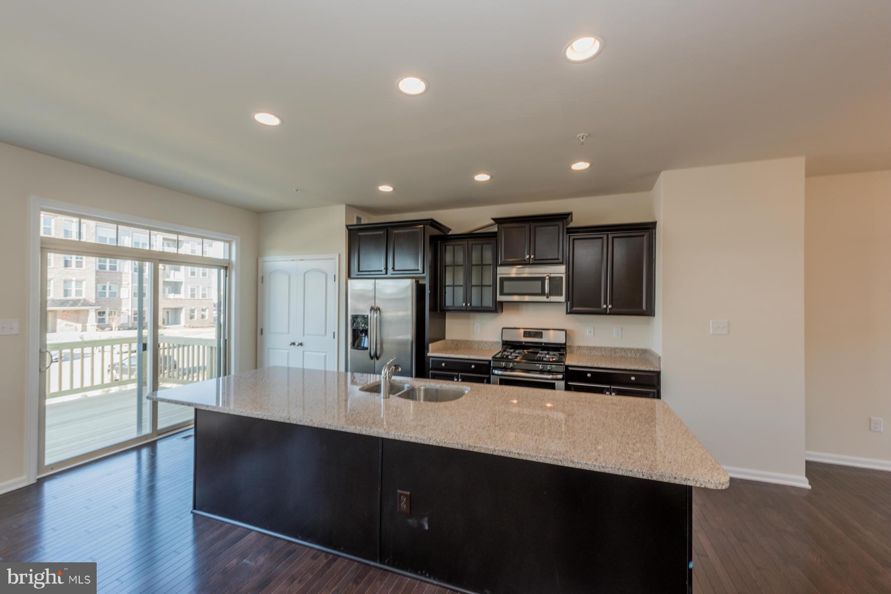 4716 Cambria Road Frederick, MD 21703 - Photo 9 of 27 a kitchen with stainless steel appliances a sink stove and refrigerator