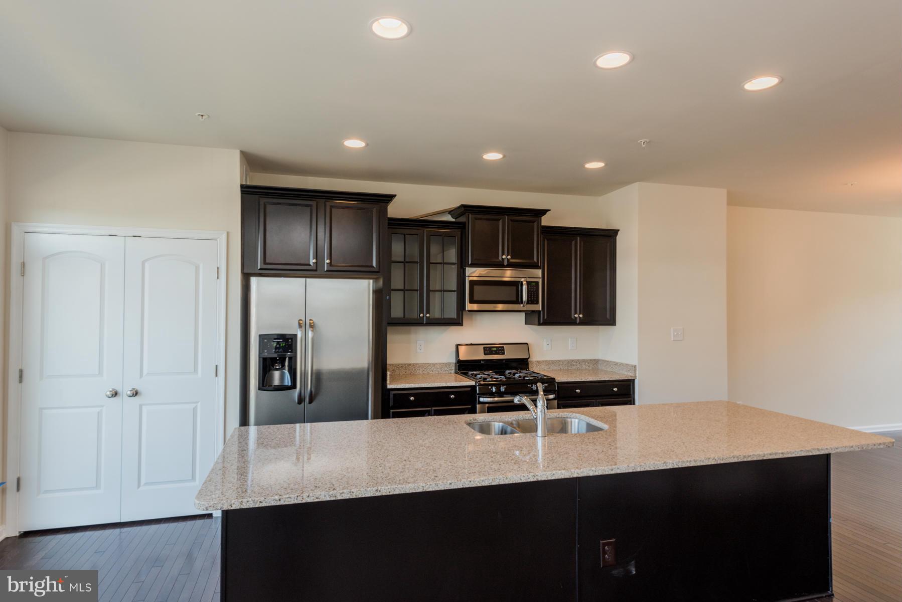 4716 Cambria Road Frederick, MD 21703 - Photo 10 of 27 a kitchen with stainless steel appliances a refrigerator and a stove top oven