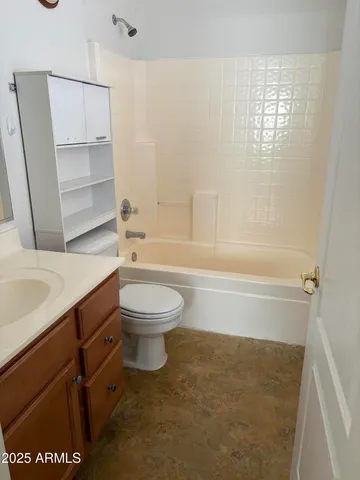 a bathroom with a toilet a sink and bathtub