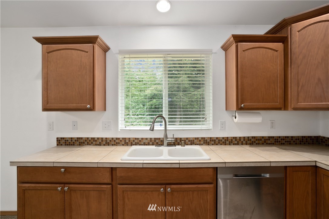 4337 Maytown Road Southwest Olympia, WA 98512 - Photo 13 of 30 a sink with a window and cabinets