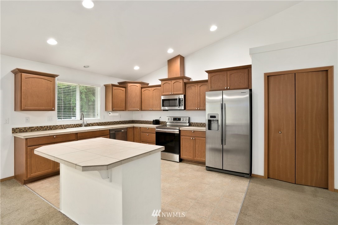 4337 Maytown Road Southwest Olympia, WA 98512 - Photo 10 of 30 a kitchen with stainless steel appliances a refrigerator sink and stove