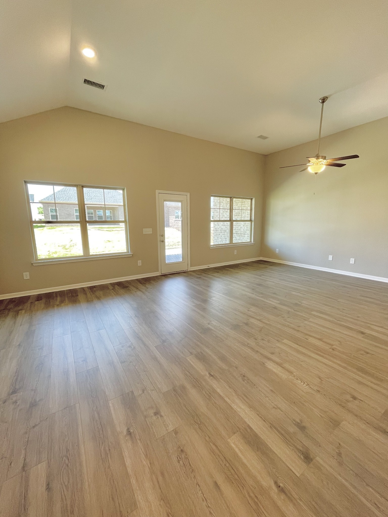 704 Rex Dr Spring Hill Spring Hill, TN 37174 - Photo 11 of 21 an empty room with wooden floor and windows