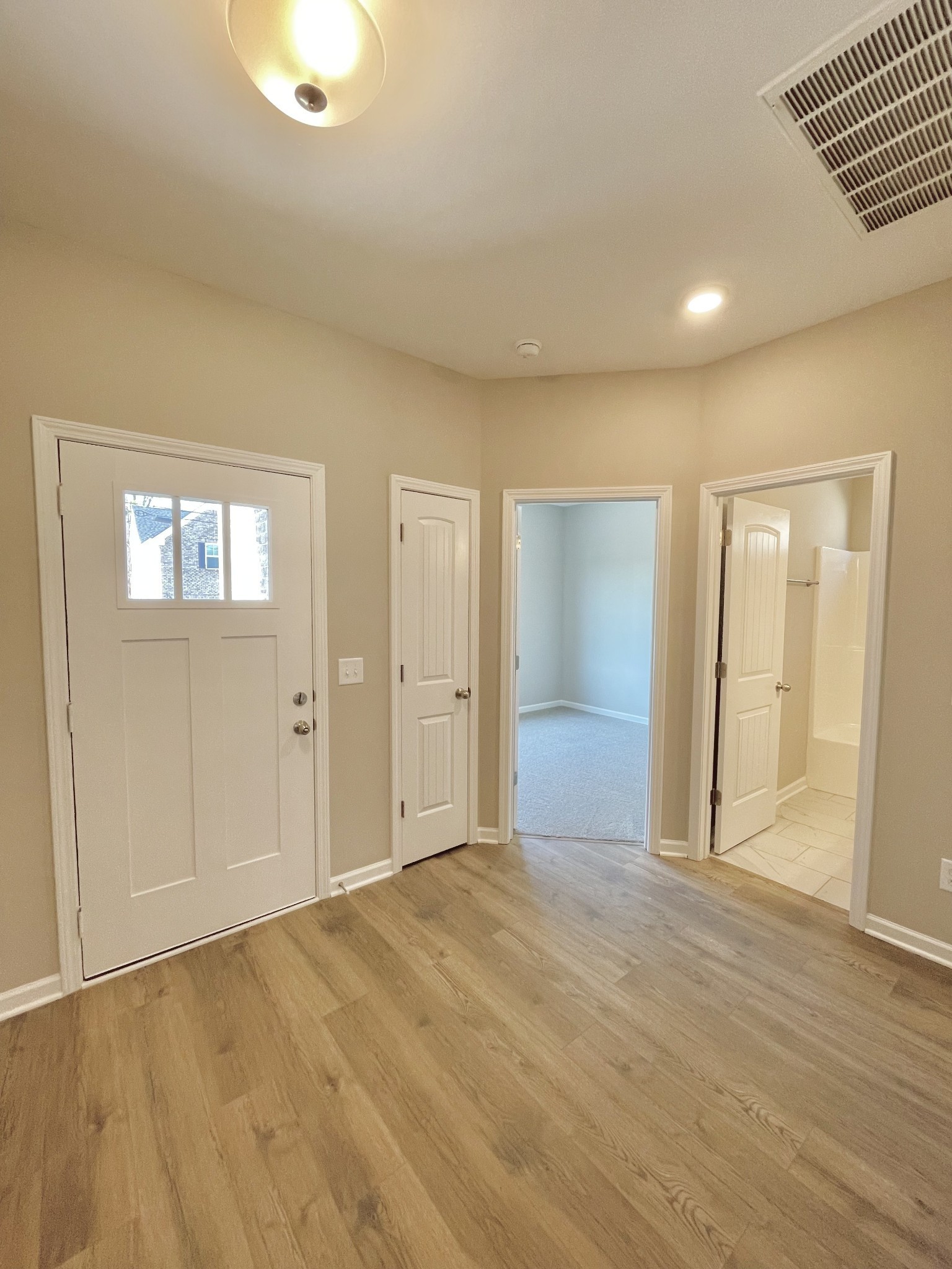 704 Rex Dr Spring Hill Spring Hill, TN 37174 - Photo 3 of 21 an empty room with wooden floor and windows