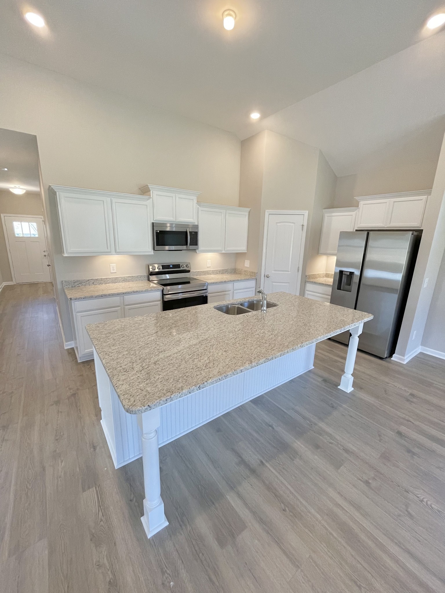 704 Rex Dr Spring Hill Spring Hill, TN 37174 - Photo 8 of 21 a kitchen with granite countertop a stove and a wooden floor