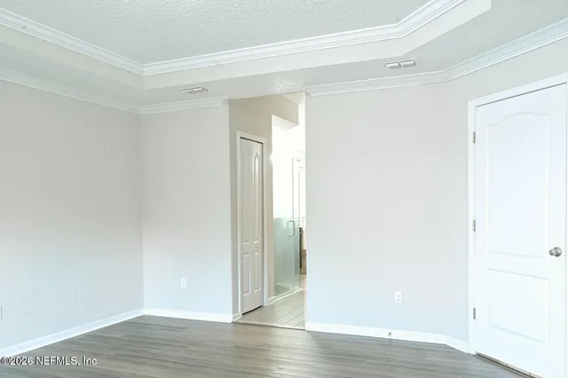 a view of an empty room with wooden floor