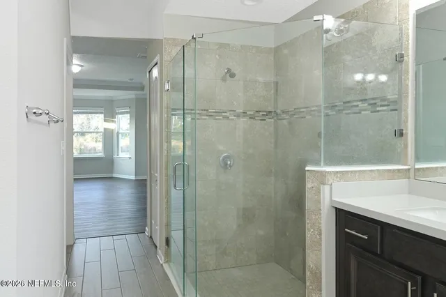 a bathroom with a shower and a sink