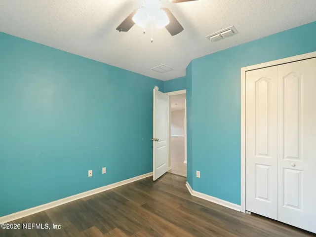 a view of room with window and wooden floor