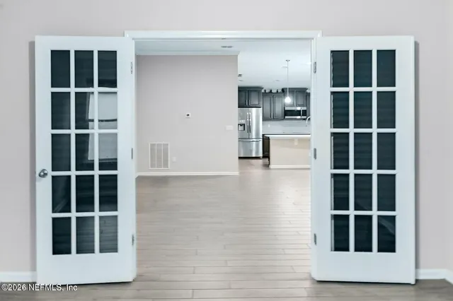 a view of kitchen with cabinets and window