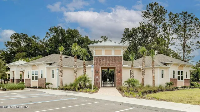 a front view of a house with swimming pool and furniture