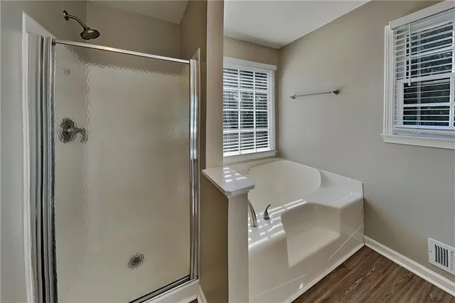 a bathroom with a tub and shower
