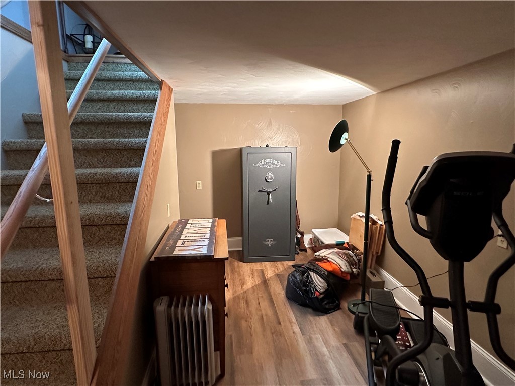 354 Big Bass Road Willard, OH 44890 - Photo 29 of 29 Exercise room featuring wood-type flooring and radiator heating unit
