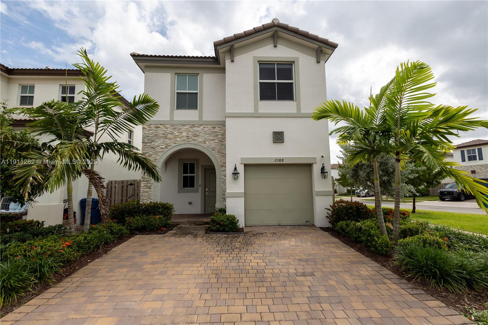a front view of a house with a garden