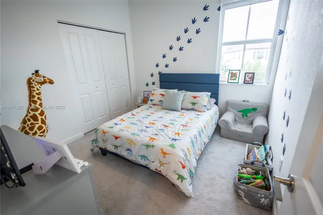 a bedroom with bed and a window