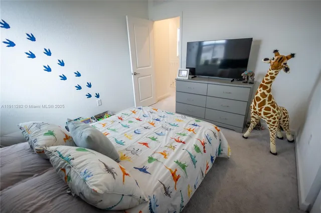 a bedroom with a bed and flat screen tv