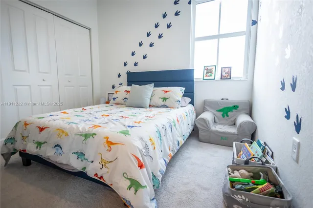 a bedroom with bed and a window